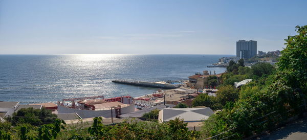 High angle view of townscape by sea against sky