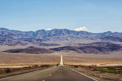 Country road leading towards mountains