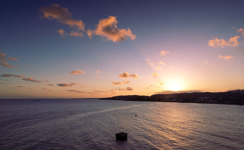 Scenic view of beach against sky during sunset