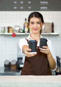 Portrait of a young woman with coffee cup