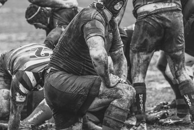 Low section of men working on field