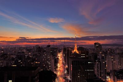 High angle view of illuminated buildings against sky during sunset