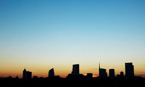 Silhouette of buildings against clear sky