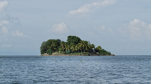 Island at sea against sky