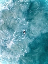 Man surfing in sea topdown 
