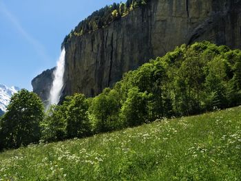 Scenic view of waterfall against sky