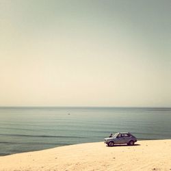 Side view of a car on the beach