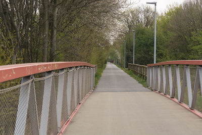 Footbridge amidst trees in forest