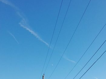 Low angle view of vapor trail against blue sky