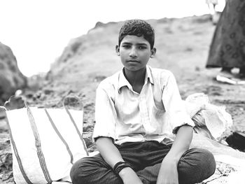 Portrait of young man sitting outdoors
