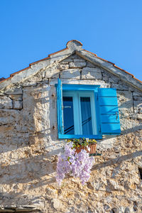 Low angle view of old building against clear blue sky