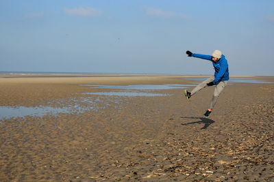 Man on beach against sky