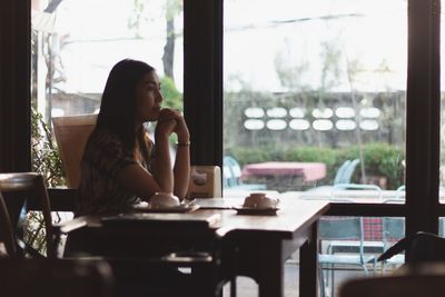 Young woman sitting on table