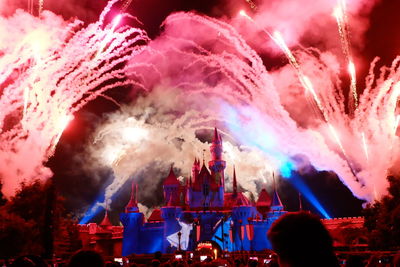 Low angle view of firework display at night