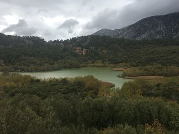 Scenic view of lake and mountains against sky