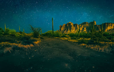 Scenic view of land against sky at night