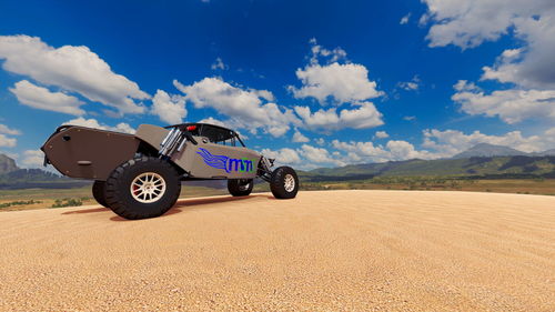 Vintage car on desert land against sky