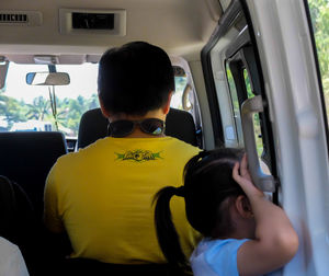 Rear view of man traveling in bus