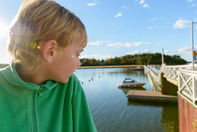 Portrait of boy looking at water