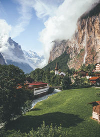 Scenic view of mountain range against cloudy sky