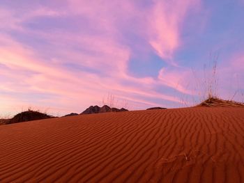 Scenic view of desert against sky during sunset