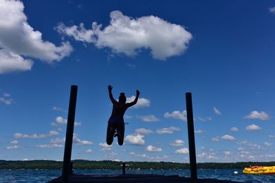 Woman jumping in sea