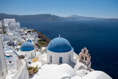 Panoramic view of sea and mountains against blue sky