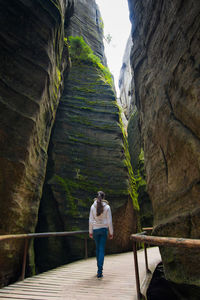 Rear view of woman standing on walkway