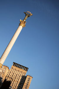 Low angle view of statue against building