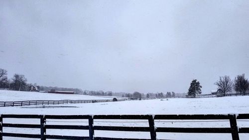 Snow covered landscape against clear sky