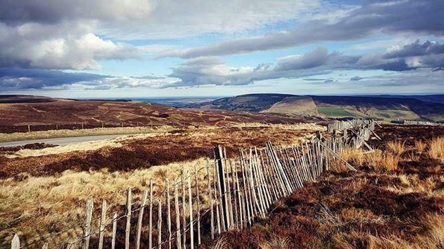 landscape, sky, tranquil scene, tranquility, scenics, mountain, cloud - sky, field, beauty in nature, nature, grass, cloud, cloudy, rural scene, horizon over land, fence, non-urban scene, mountain range, remote, agriculture