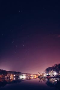 Illuminated city against sky at night