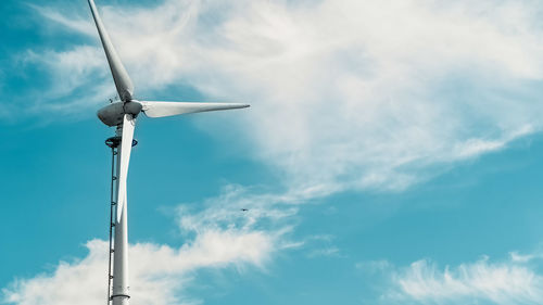 Low angle view of wind turbine against sky