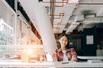 Portrait of a woman working on table