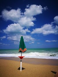 Lifeguard hut on beach against sky