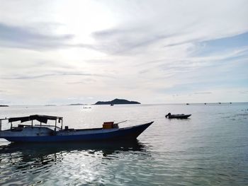 Boats in sea against sky