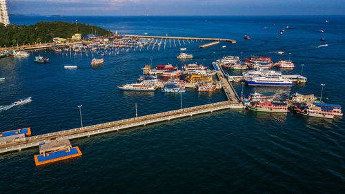 High angle view of city by sea against sky