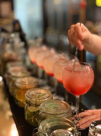 Close-up of hand pouring wine in glass