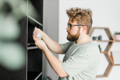 Side view of man using mobile phone