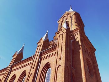 Low angle view of traditional building against blue sky