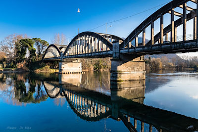 Bridge over river against blue sky
