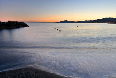 Scenic view of sea against sky at sunset