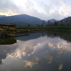 Scenic view of lake and mountains against sky