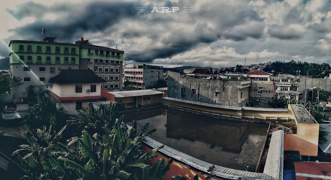 PANORAMIC VIEW OF CITY AGAINST STORM CLOUDS