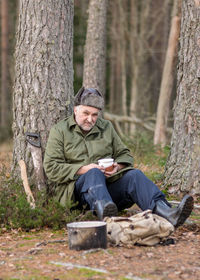 Portrait of senior man sitting in forest