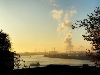 Scenic view of river against sky at sunset