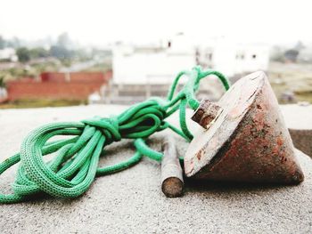 Close-up of rusty metal and rope