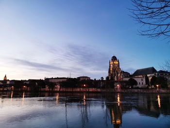 Reflection of buildings in lake at dusk