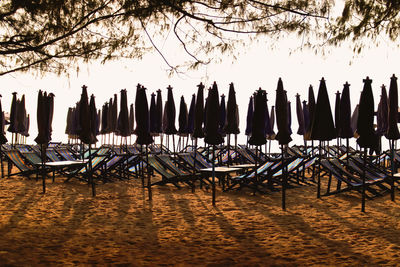 Chairs on beach against sky