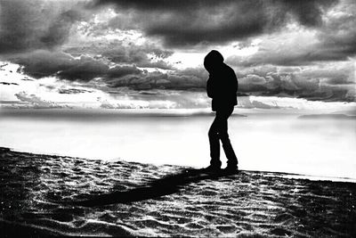 Scenic view of beach against cloudy sky